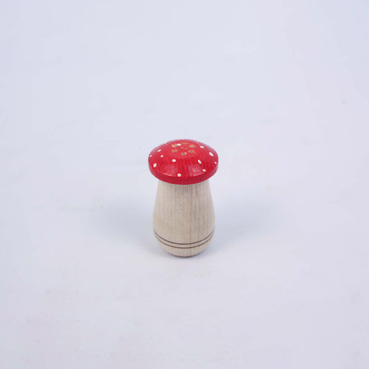 Small Salt Shaker With a Red Cap In The Shape Of a Mushroom